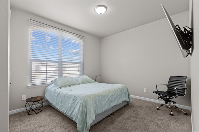 bedroom featuring carpet floors and baseboards