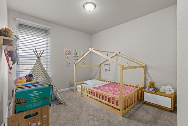 bedroom featuring carpet and baseboards