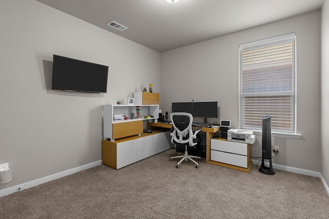 carpeted home office with baseboards and visible vents