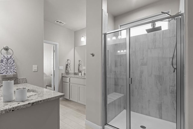 full bath with a stall shower, visible vents, and vanity