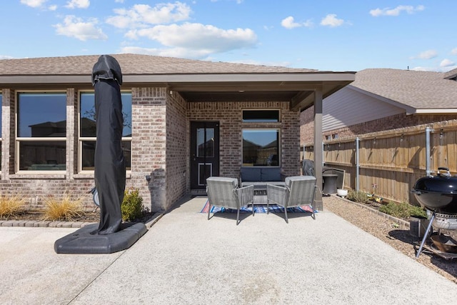 view of patio / terrace with area for grilling, fence, and an outdoor living space