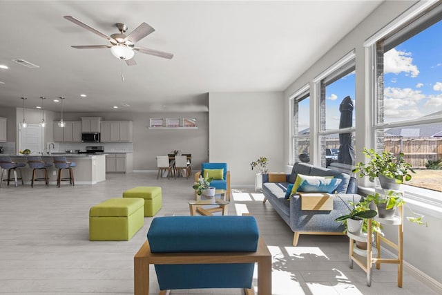 living room featuring recessed lighting, visible vents, light wood-style flooring, ceiling fan, and baseboards