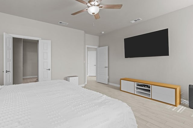 bedroom with light wood-type flooring, visible vents, and baseboards