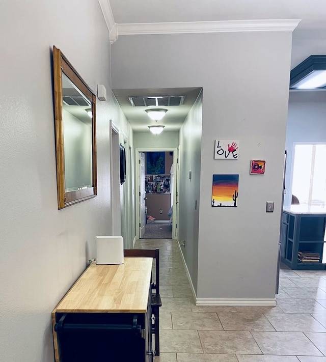 corridor with baseboards, visible vents, crown molding, and light tile patterned flooring