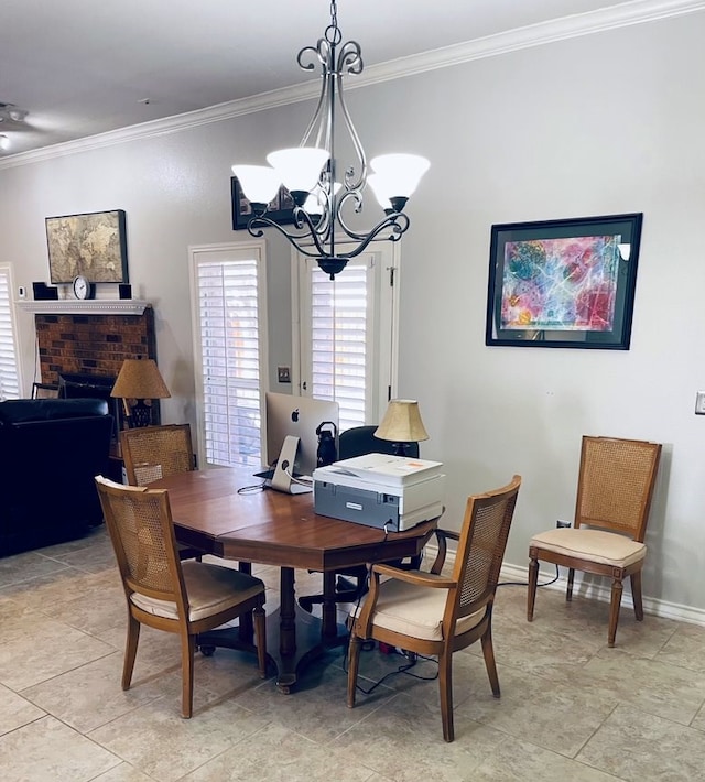 dining room featuring baseboards, crown molding, a brick fireplace, a notable chandelier, and light tile patterned flooring