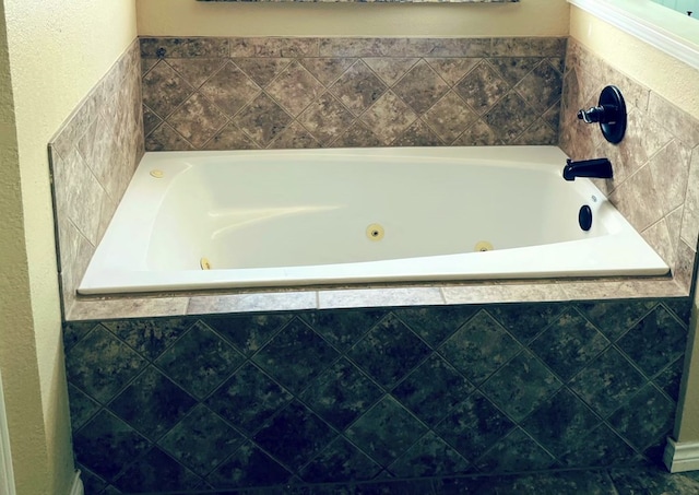 bathroom with a tub with jets