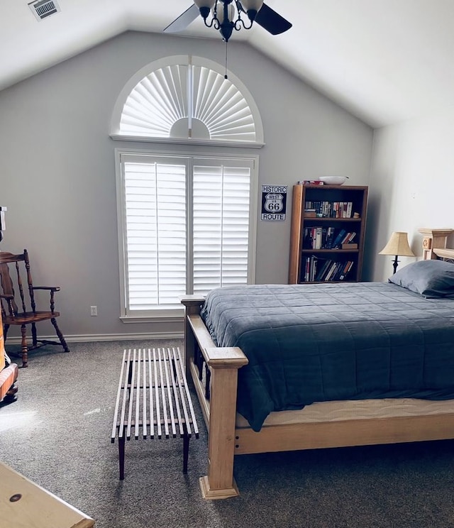 carpeted bedroom with ceiling fan, visible vents, vaulted ceiling, and baseboards