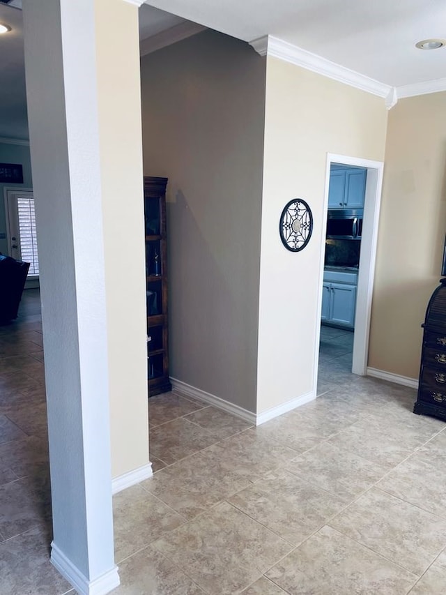 interior space featuring baseboards and ornamental molding