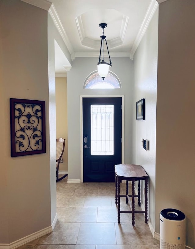 foyer featuring baseboards, a tray ceiling, light tile patterned floors, and crown molding