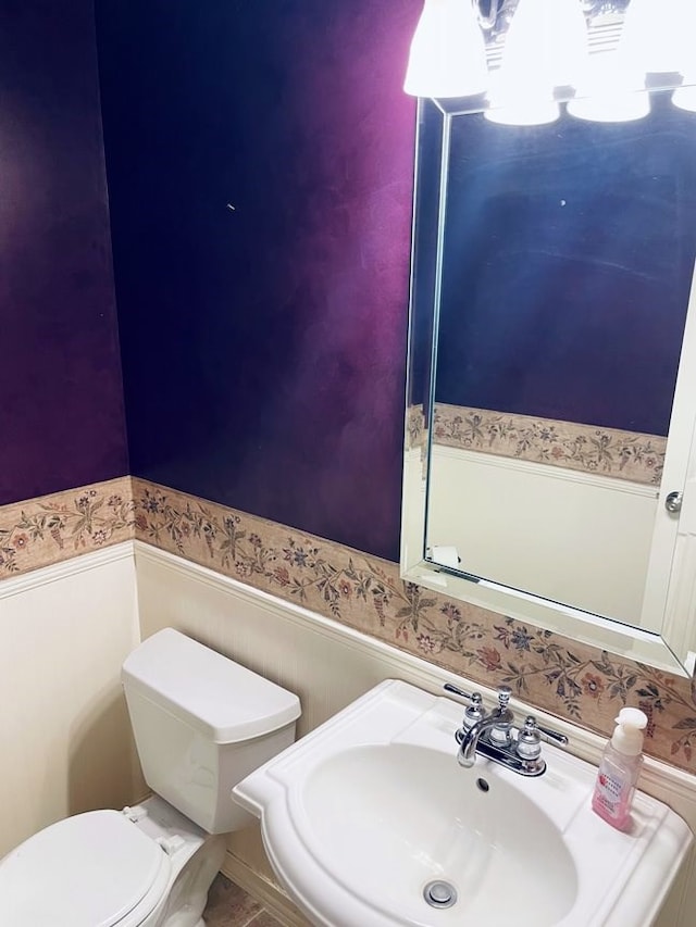 half bathroom with a sink and toilet