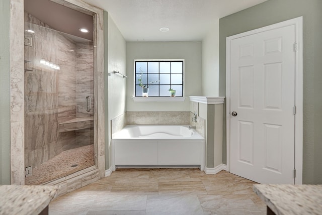 1901 College Ave, Midland, TX 79701 - bathroom with a bath, a shower stall, and marble finish floors