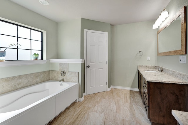 1901 College Ave, Midland, TX 79701 - bathroom with vanity, a garden tub, and baseboards