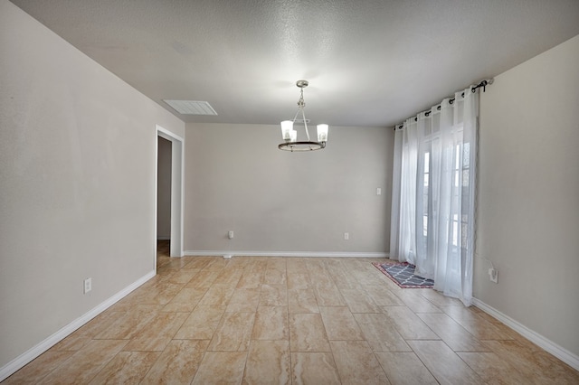 1901 College Ave, Midland, TX 79701 - spare room with a chandelier and baseboards