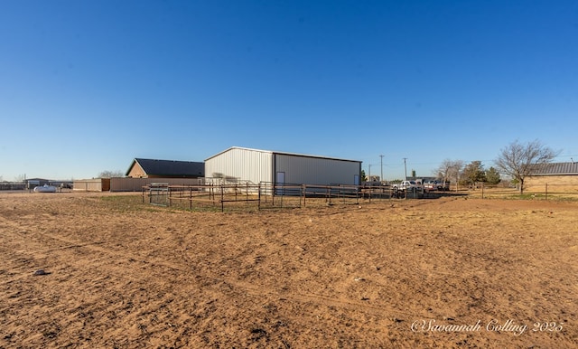 view of yard with a rural view and an outbuilding