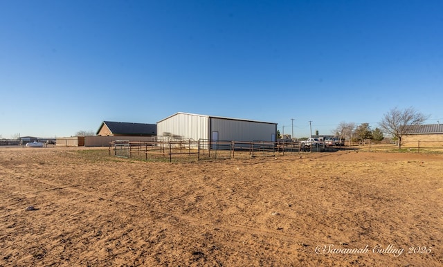 view of yard with a rural view and an outdoor structure