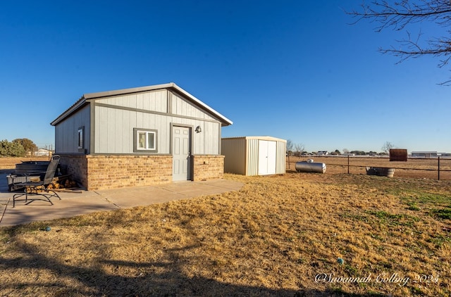 exterior space featuring a patio area and a shed