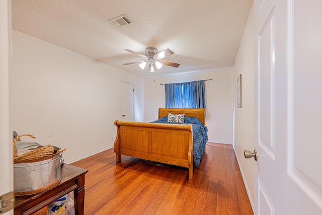 2807 Ann Dr, Midland, TX 79705 - bedroom featuring light wood-style floors, ceiling fan, a textured ceiling, and baseboards