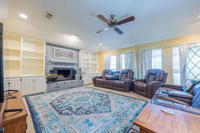 2807 Ann Dr, Midland, TX 79705 - living room featuring ceiling fan, a textured ceiling, a brick fireplace, built in shelves, and recessed lighting
