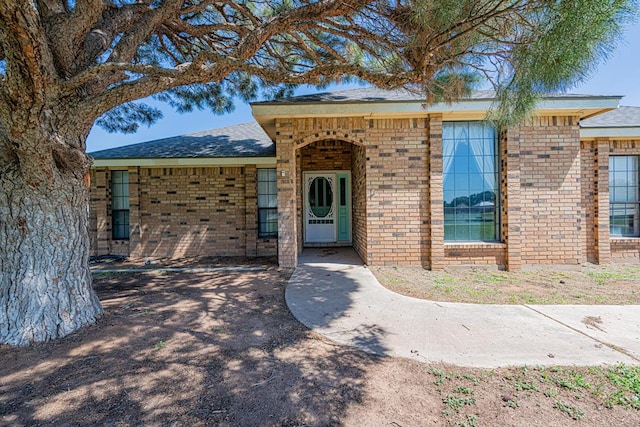 2807 Ann Dr, Midland, TX 79705 - doorway to property featuring brick siding and roof with shingles