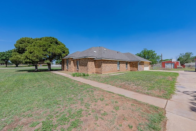 2807 Ann Dr, Midland, TX 79705 - view of home's exterior featuring concrete driveway, an attached garage, a lawn, and brick siding