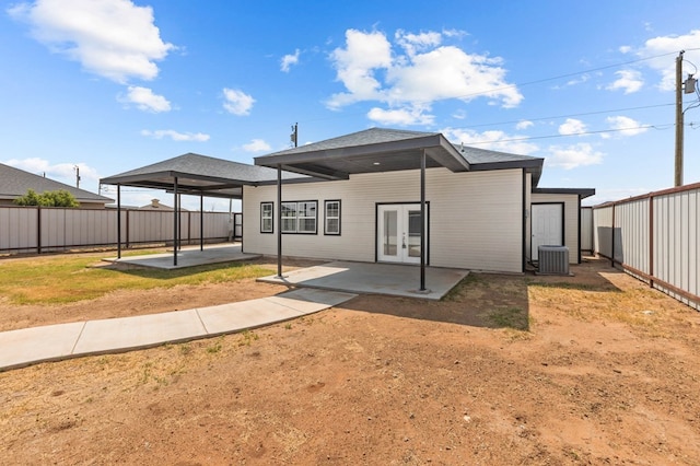 back of property with french doors, central AC unit, and a patio area