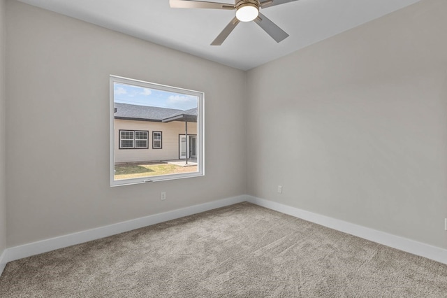 carpeted spare room featuring ceiling fan