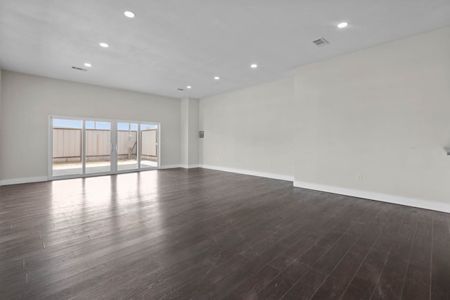 spare room with dark wood-type flooring