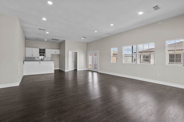 unfurnished living room featuring dark hardwood / wood-style flooring