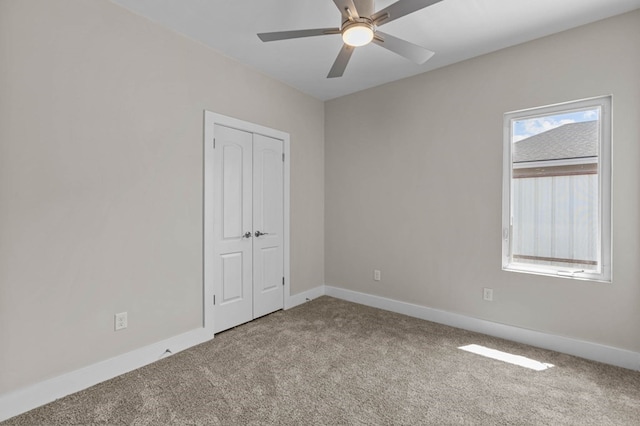 unfurnished room with light colored carpet and ceiling fan