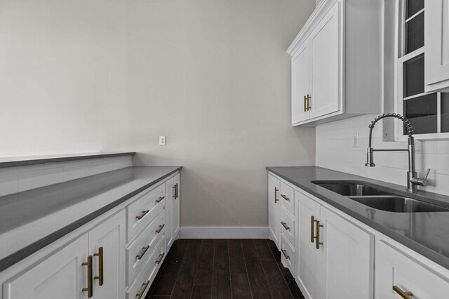 kitchen with white cabinets, dark hardwood / wood-style flooring, and sink