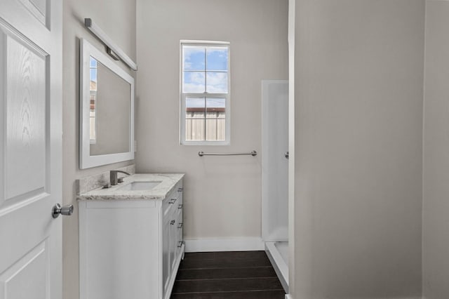 bathroom with vanity and a shower