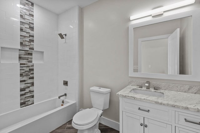 full bathroom with vanity, tiled shower / bath combo, and toilet