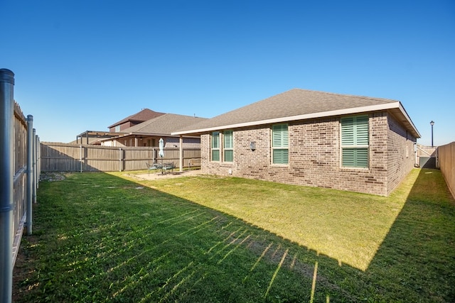 rear view of property with a yard