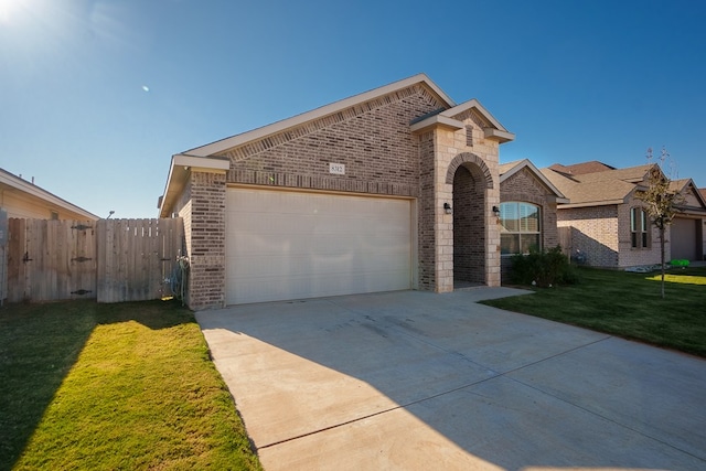 view of front of property featuring a front yard and a garage