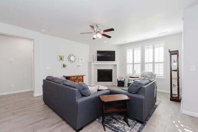 living room featuring light hardwood / wood-style floors and ceiling fan