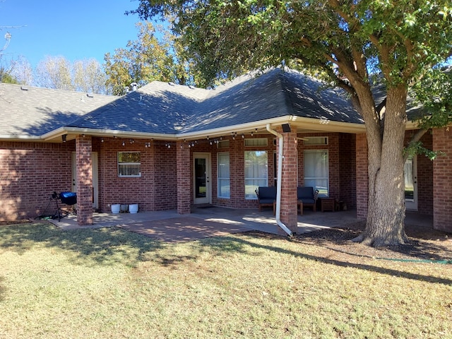 rear view of property with outdoor lounge area, a patio area, and a yard