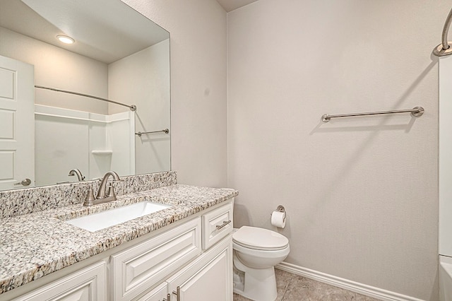 bathroom featuring vanity, toilet, and walk in shower