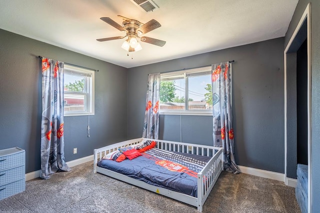 702 Dellwood St, Midland, TX 79701 - bedroom with multiple windows, carpet, baseboards, and a ceiling fan