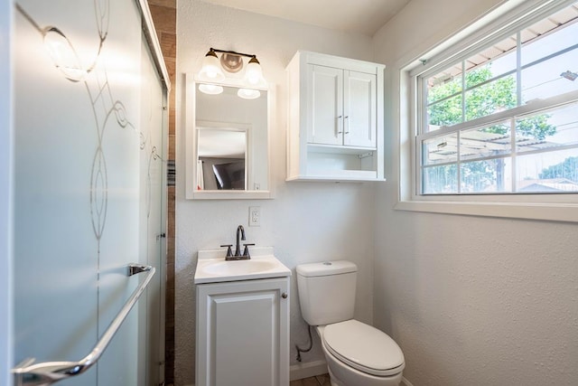 702 Dellwood St, Midland, TX 79701 - bathroom with vanity, toilet, and a textured wall
