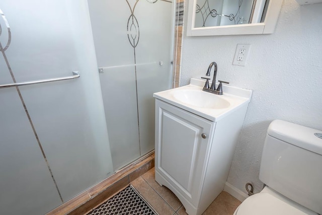 702 Dellwood St, Midland, TX 79701 - full bathroom featuring toilet, vanity, a shower, and tile patterned floors