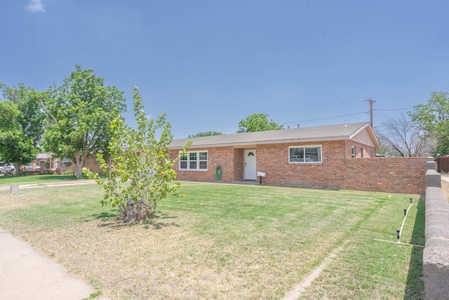 702 Dellwood St, Midland, TX 79701 - ranch-style home with a front yard and brick siding