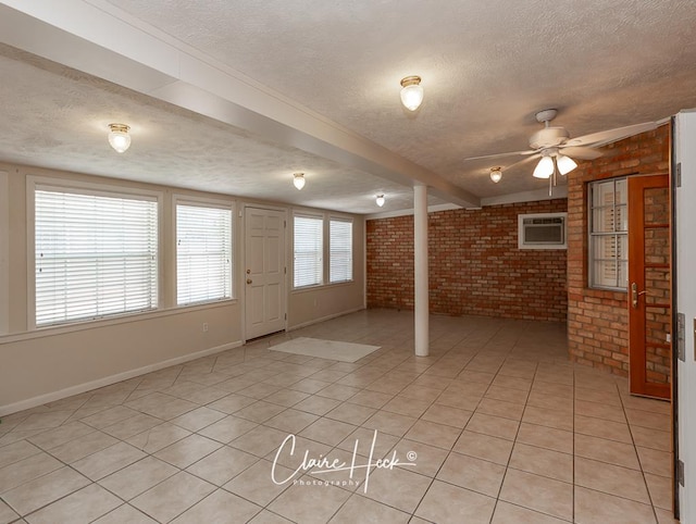 3307 Stanolind Ct, Midland, TX 79707 - entrance foyer featuring a textured ceiling, brick wall, an AC wall unit, light tile patterned floors, and ceiling fan