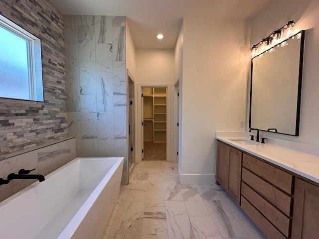 bathroom featuring shower with separate bathtub and vanity