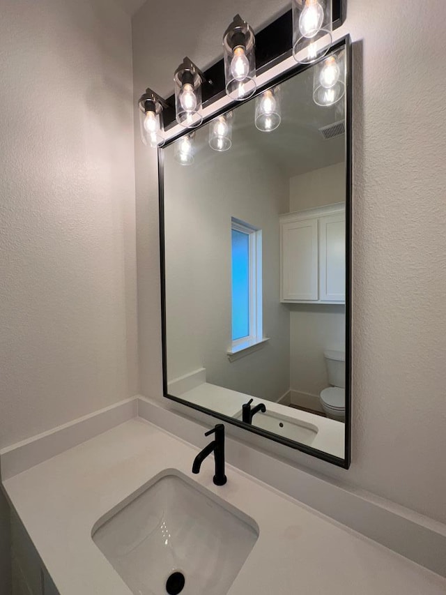 bathroom with vanity and toilet