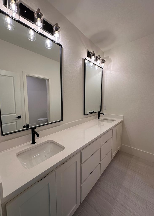 bathroom featuring vanity and toilet