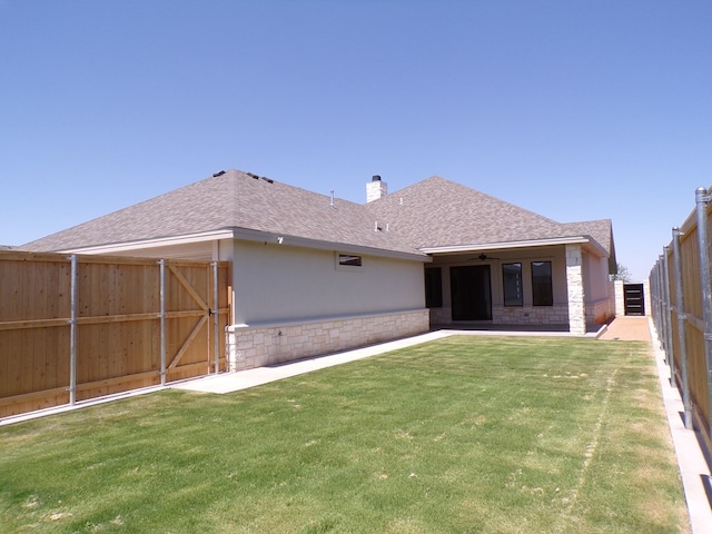 rear view of property with a yard