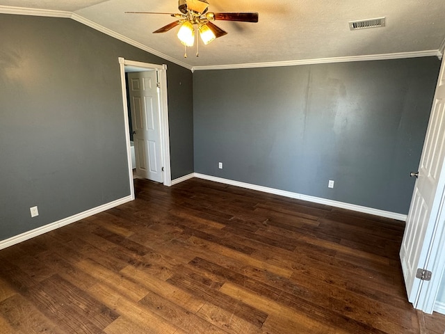 spare room featuring visible vents, a ceiling fan, ornamental molding, dark wood-style flooring, and vaulted ceiling