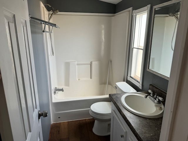 bathroom with shower / tub combination, vanity, toilet, and wood finished floors