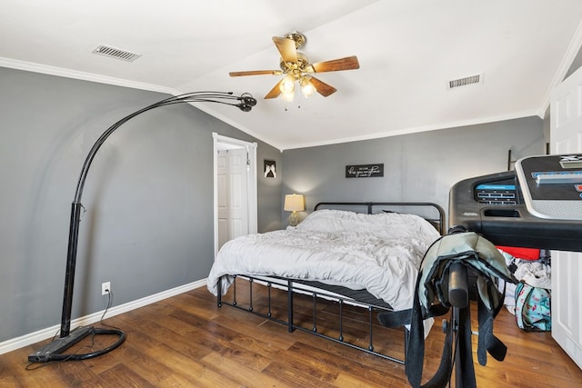 bedroom featuring ornamental molding, wood finished floors, and visible vents