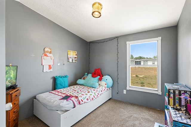 carpeted bedroom with lofted ceiling and a textured ceiling